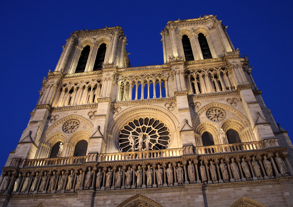 Notre Dame Cathedral illuminated at dusk.